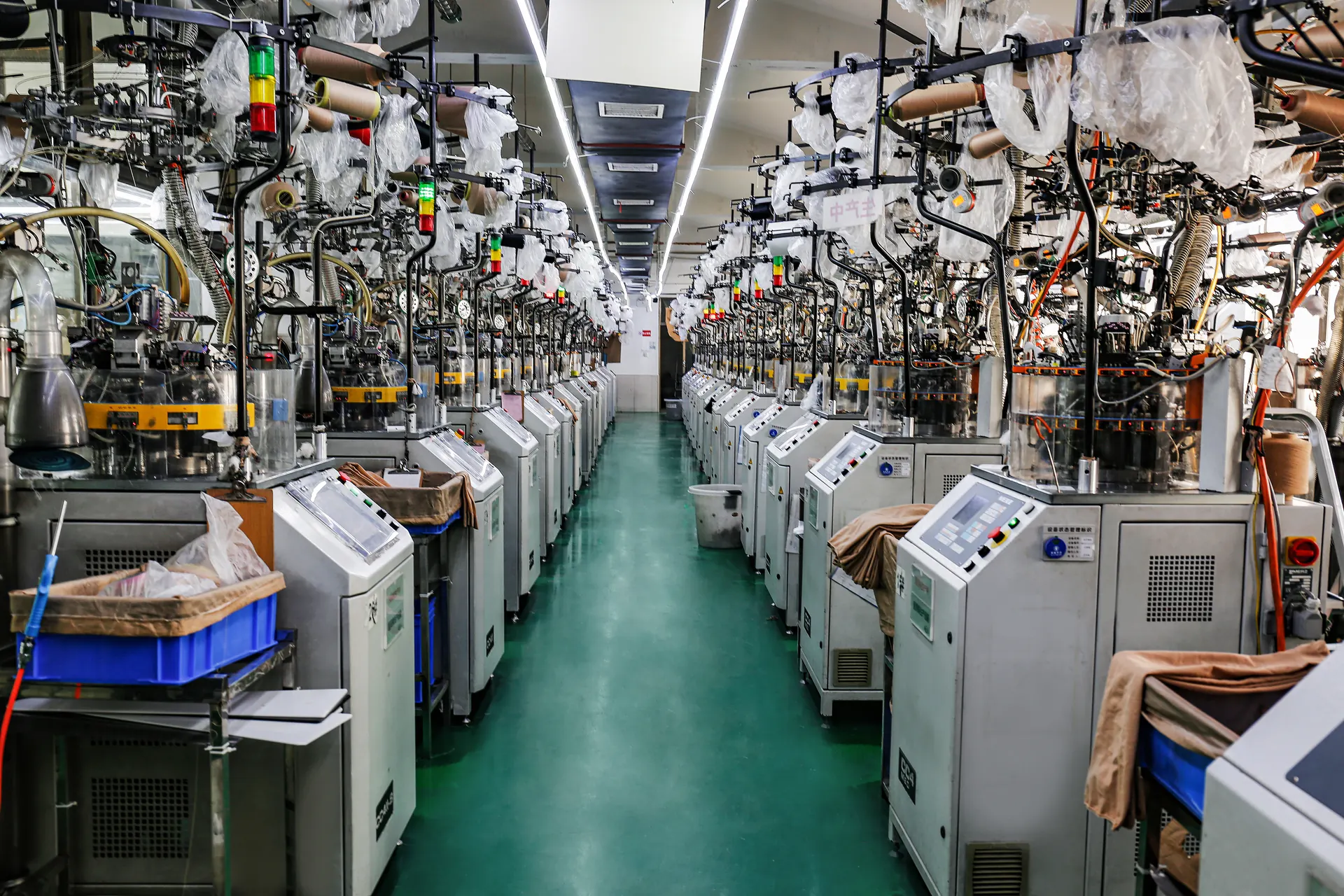 Filas de máquinas de tejido en el taller de producción de Xinran